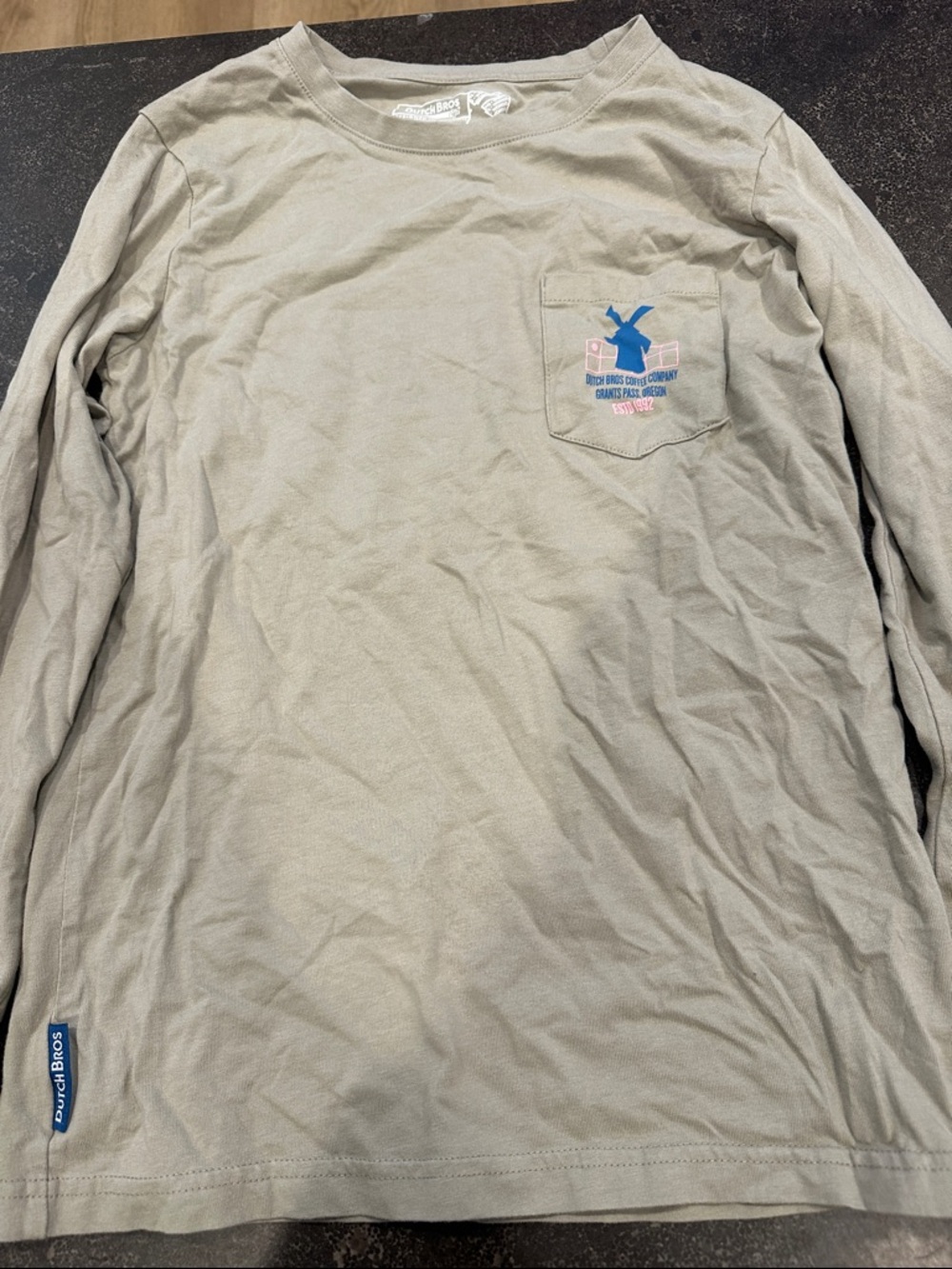 Dutch Bros Long-Sleeve Pocket Tee in Light Taupe with Blue Logo